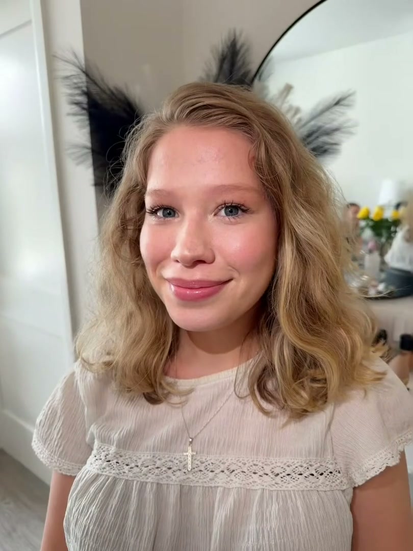 The client smiling in her finished look